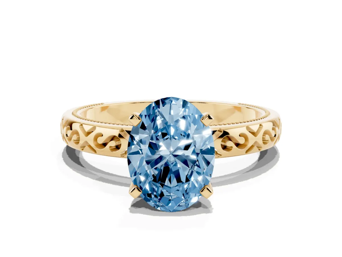 Fancy Blue Oval Cut Solitaire Engagement Ring with Scrollwork Band and Four-Prong Setting Yellow gold