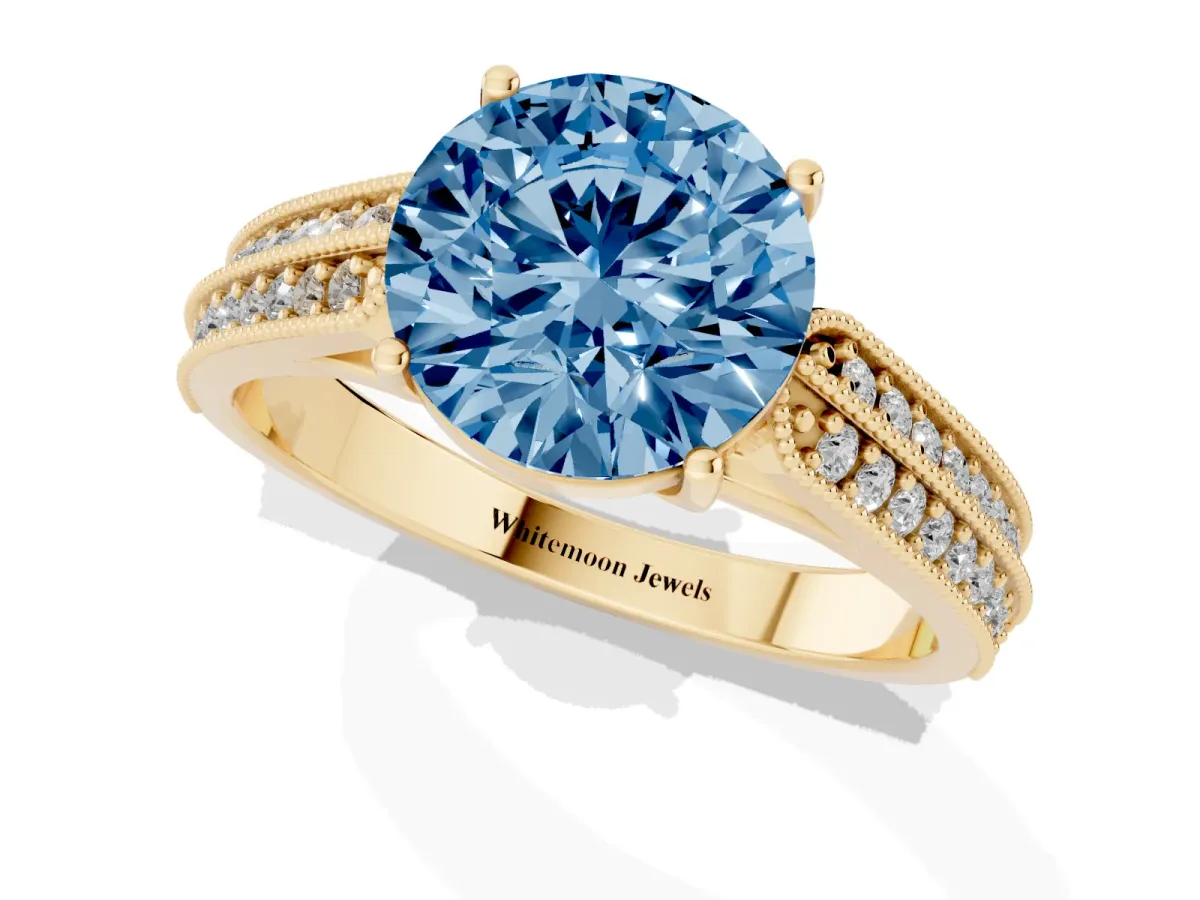 Fancy Blue Round Cut Cut Pave Split Shank Engagement Ring with Four-Prong Setting Yellow gold