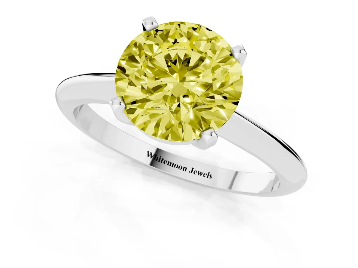 Fancy Yellow Round Cut Cut Solitaire Ring with Four-Prong Setting on a Classic Band Silver