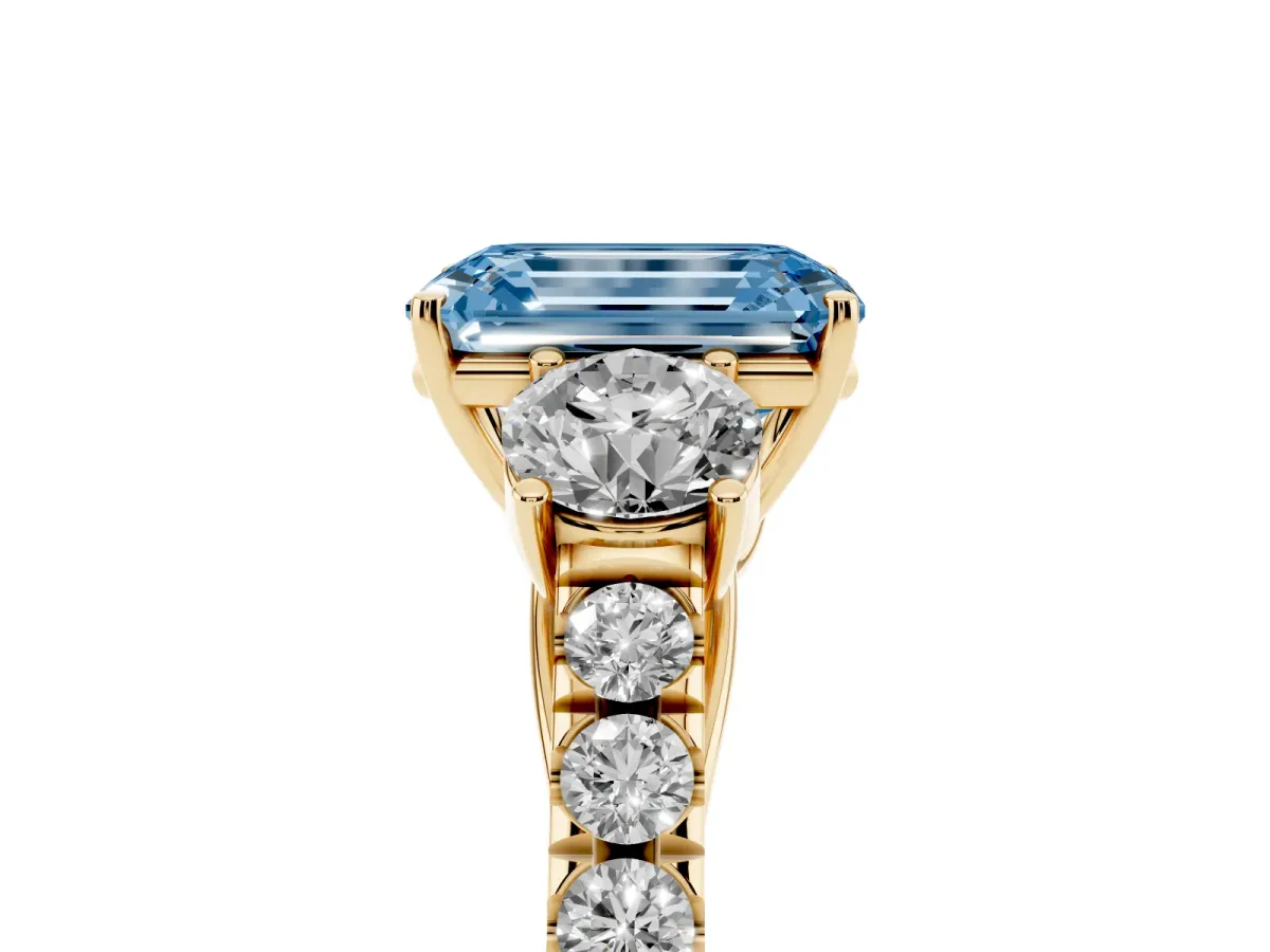 Fancy Blue Emerald Cut Cut Diamond Three-Stone Ring with Round Side Stones and Pavé Band Yellow gold