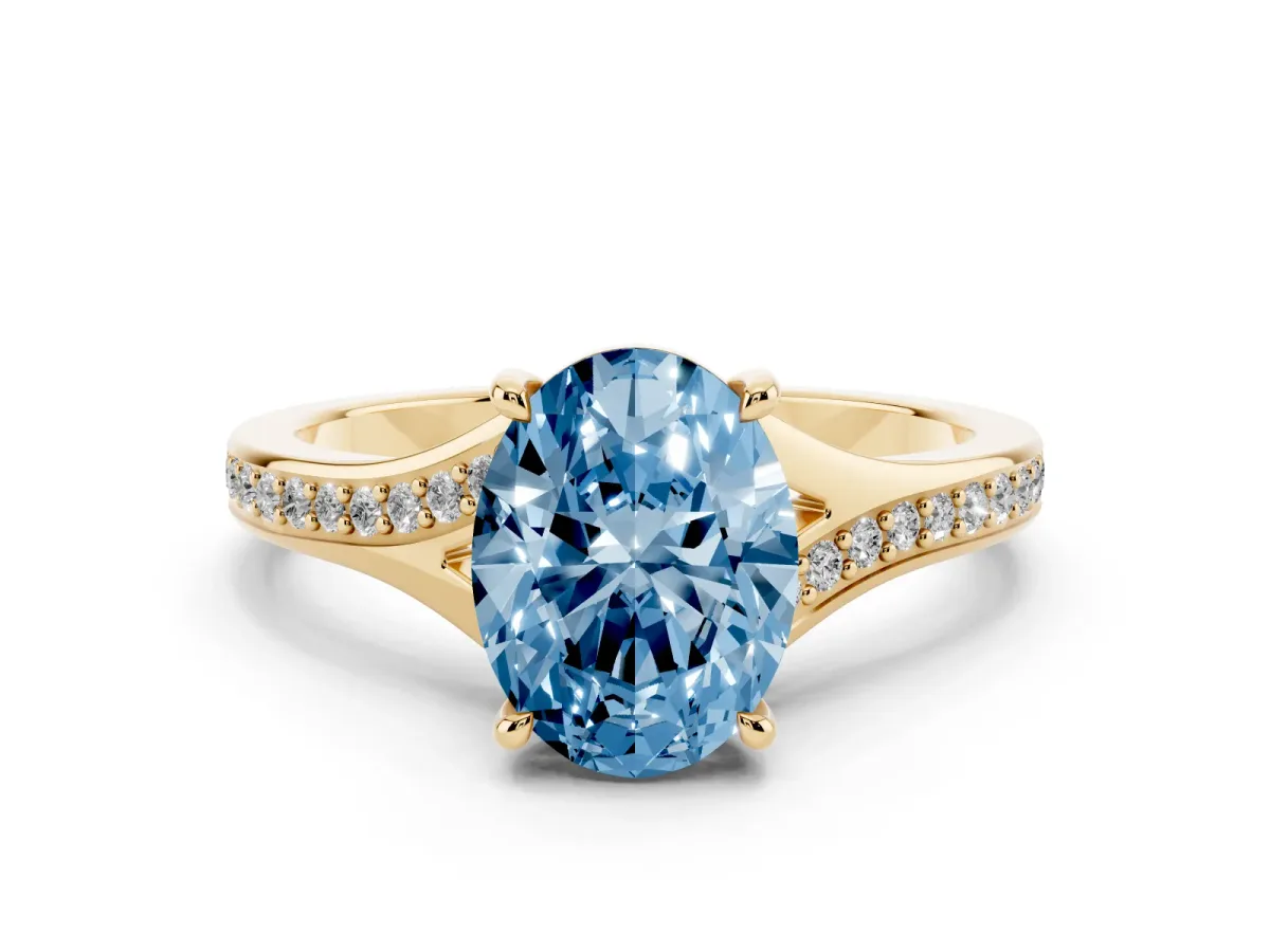 Fancy Blue Oval Cut Diamond Solitaire Ring with Pavé Band and Prong Setting Yellow gold