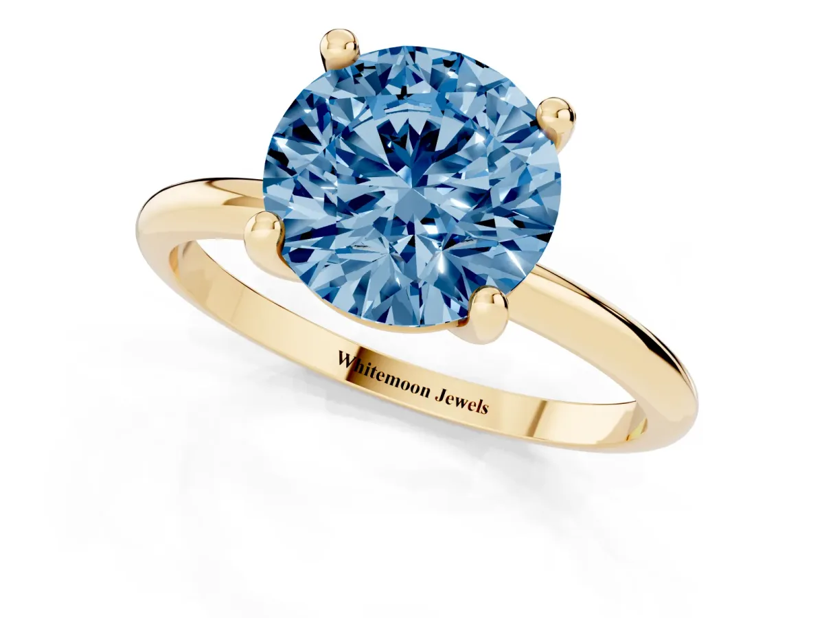 Fancy Blue Round Cut Solitaire Diamond Ring with 4-Prong Setting on a Classic Band Yellow gold