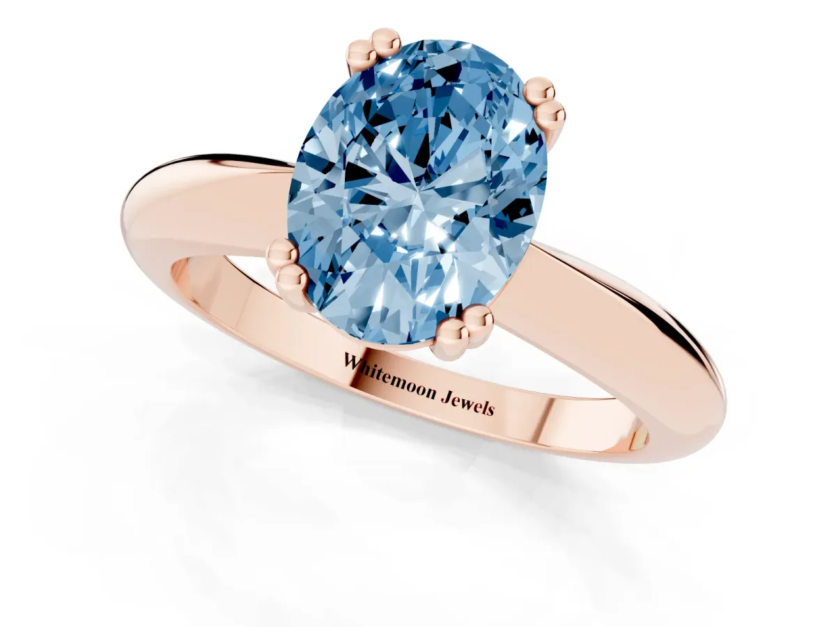 Fancy Blue Oval Cut Cut Solitaire Engagement Ring with Tapered Band and Four-Prong Setting Rose gold