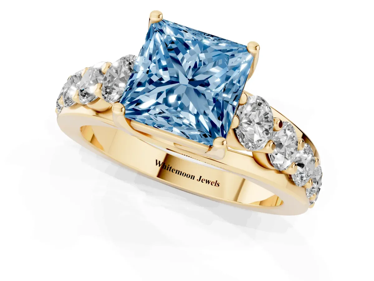 Fancy Blue Princess Cut Diamond Engagement Ring with Pavé Band and Four-Prong Setting Yellow gold