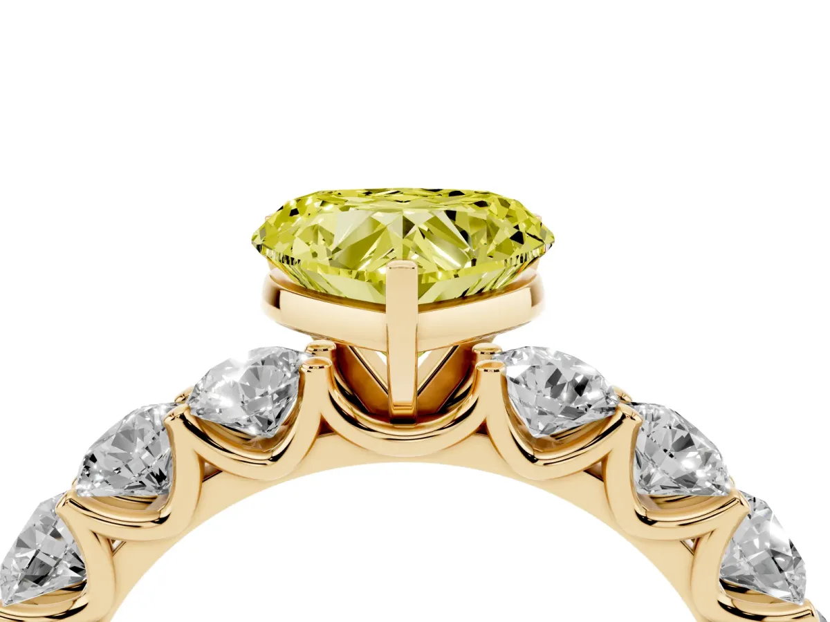 Fancy Yellow Heart Cut Diamond Prong Setting with Side Stones on a Pave Band Yellow gold