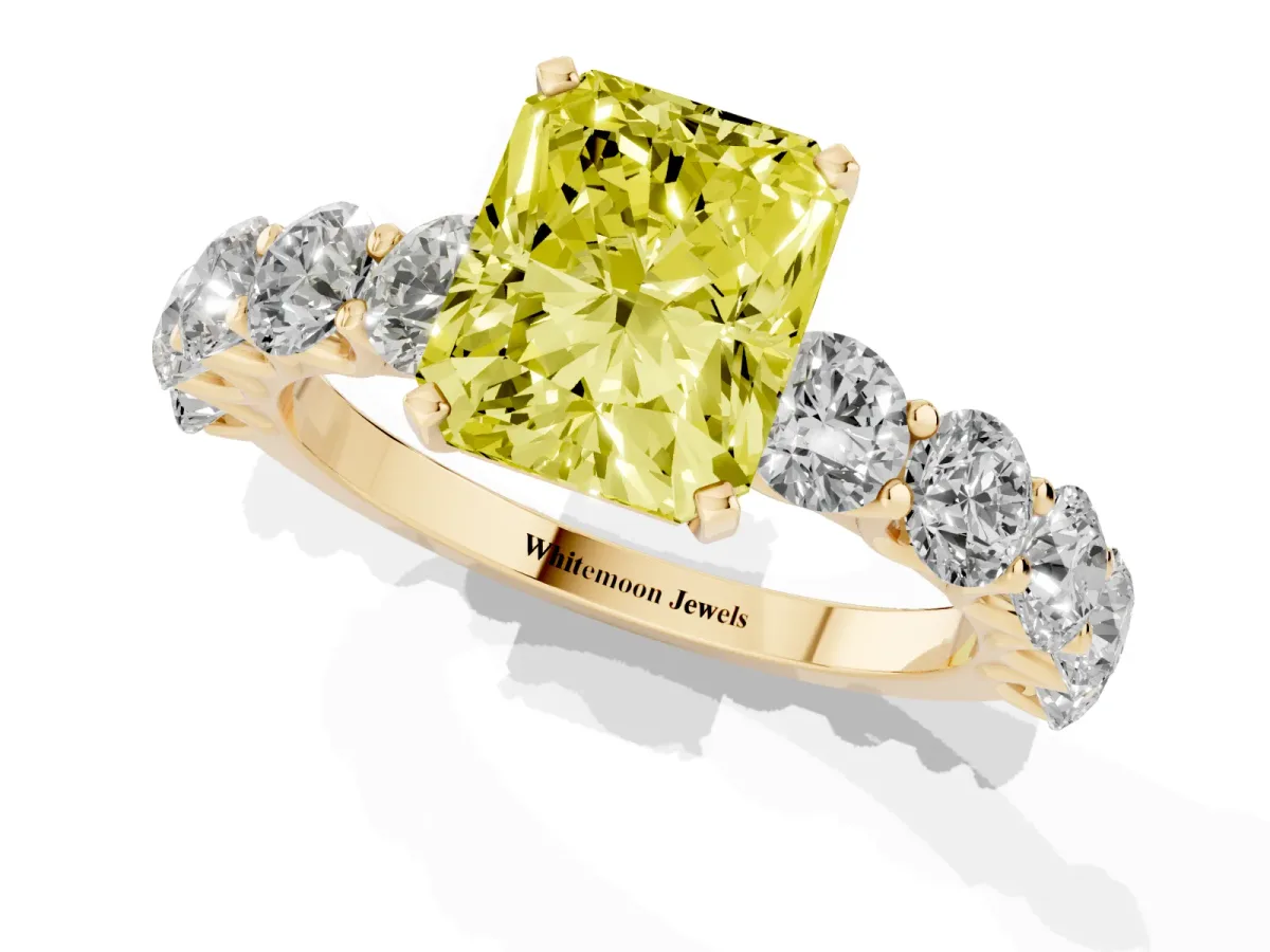 Fancy Yellow Radiant Cut Diamond Prong Setting with Side Stones on a Pave Band Yellow gold