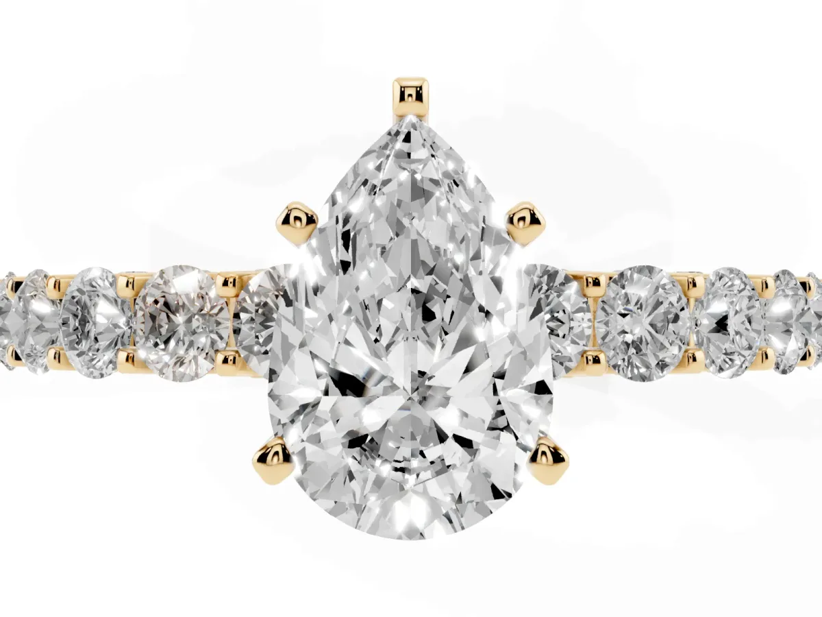 Pear Cut Diamond Solitaire Ring with Shared Prong Pavé Band and Four-Prong Setting Yellow gold