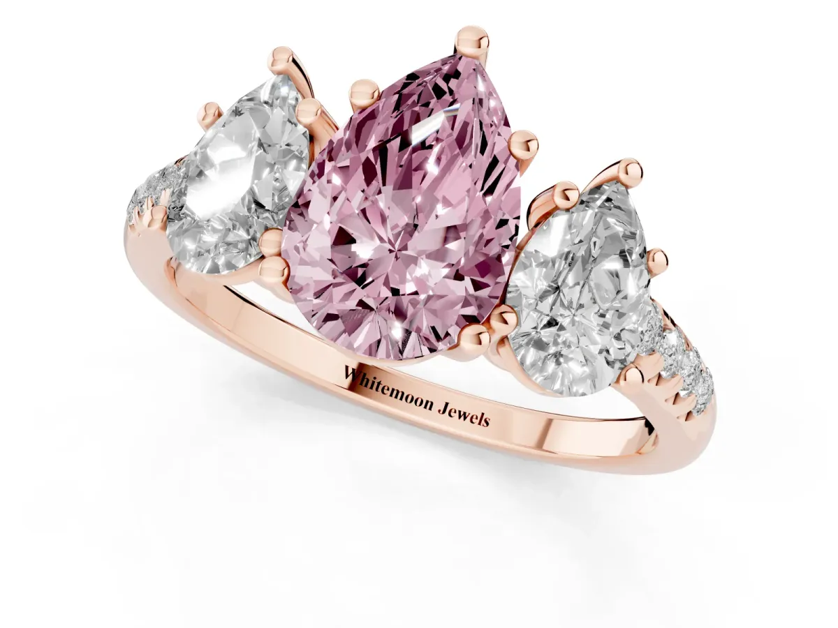 Fancy Pink Three-Stone Pear Cut Diamond Ring with Round Pavé Band and Prong Setting Rose gold