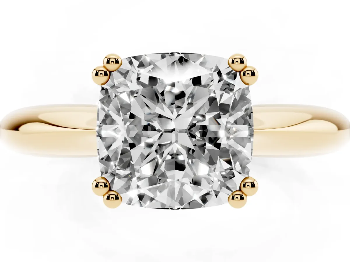 Cushion Cut Cut Solitaire Engagement Ring with Tapered Band and Four-Prong Setting Yellow gold