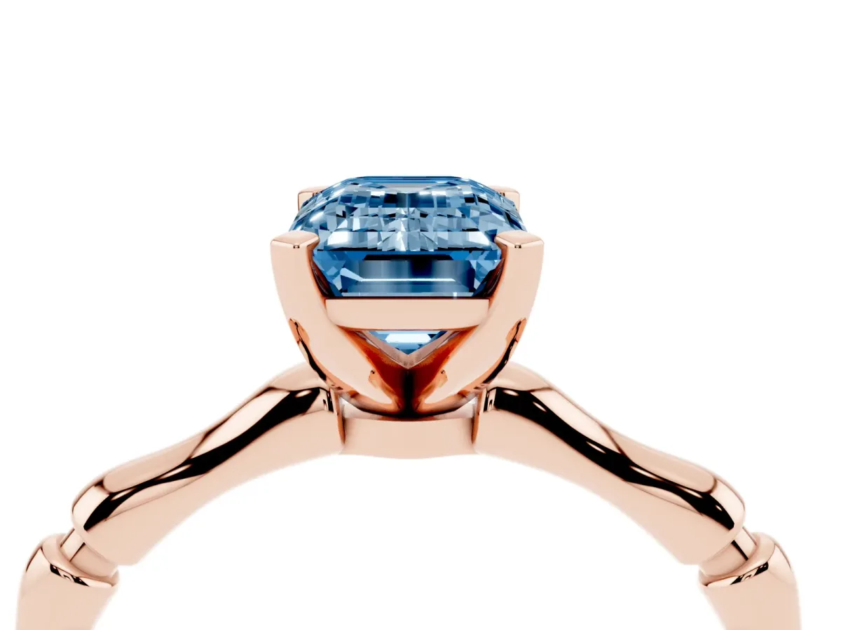 Fancy Blue Emerald Cut Solitaire Diamond Ring with Bamboo Band and Four-Prong Setting Rose gold