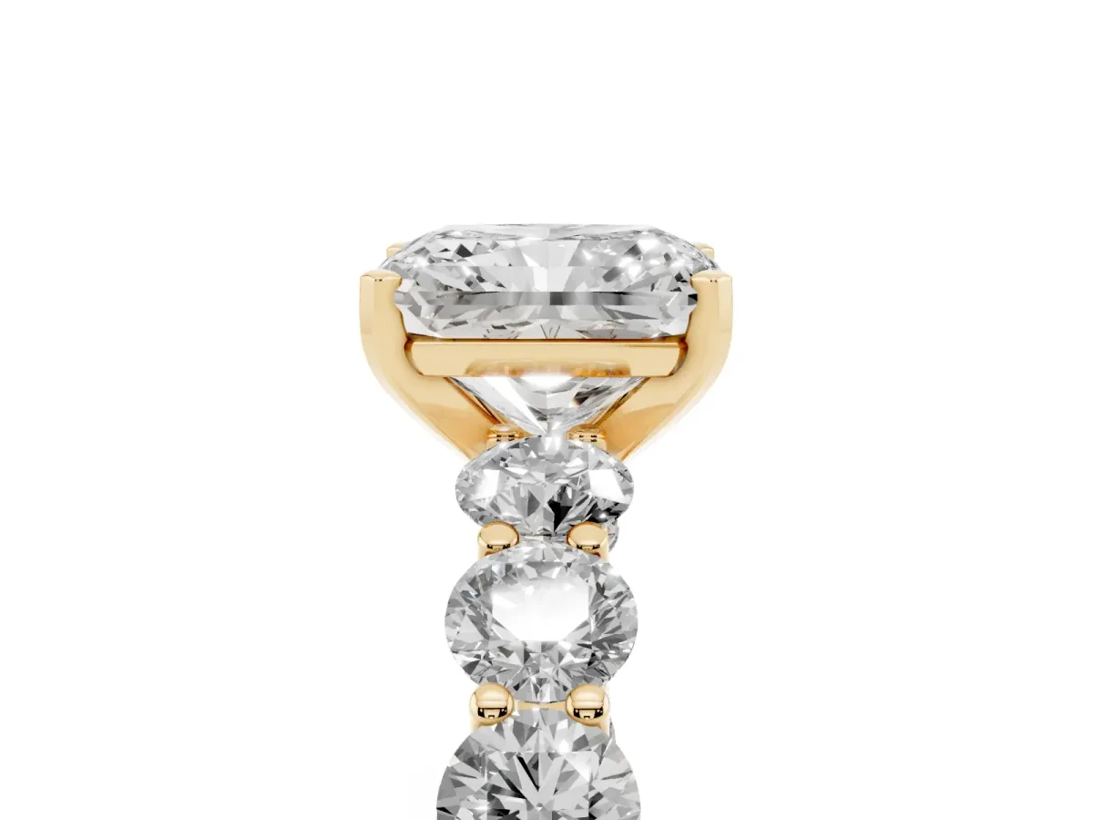 Radiant Cut Diamond Prong Setting with Side Stones on a Pave Band Yellow gold