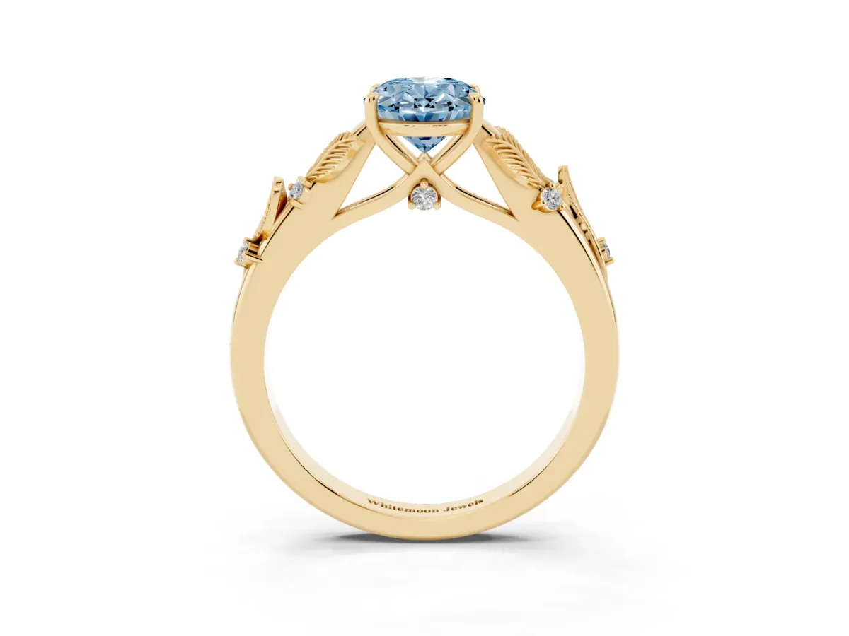 Fancy Blue Oval Cut Diamond Solitaire Ring with Leaf Motif Band and Four-Prong Setting Yellow gold