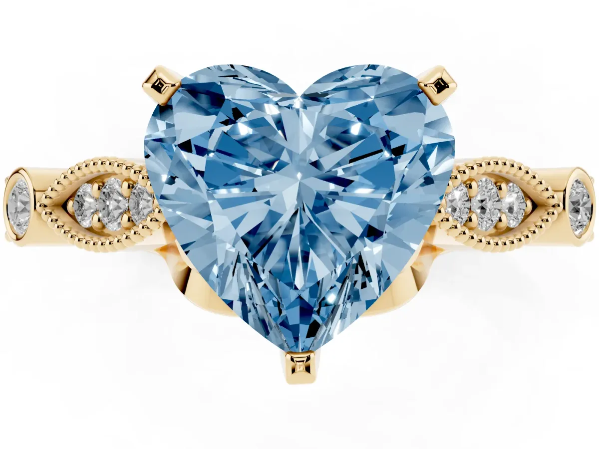 Fancy Blue Heart Cut Cut Diamond with Milgrain Marquise and Bezel Accents on a Solitaire Band with Prong Setting Yellow gold