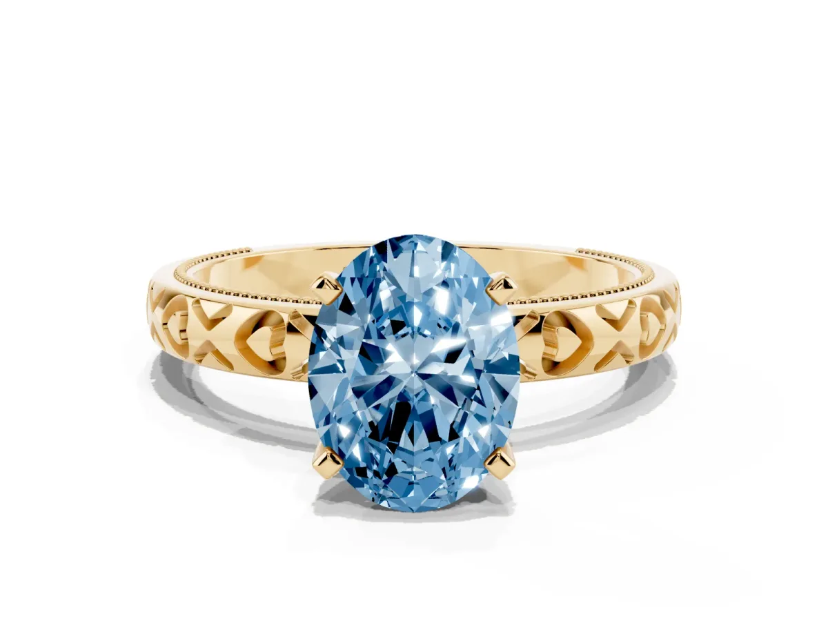 Fancy Blue Oval Cut Solitaire Diamond Engagement Ring with XO Engraved Band and Four-Prong Setting Yellow gold