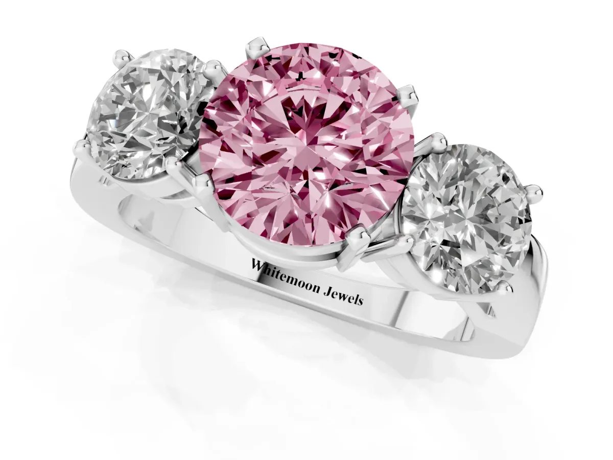 Fancy Pink Three-Stone Round Cut Diamond Ring with Round Side Stones, Classic Band, and Four-Prong Setting Platinum