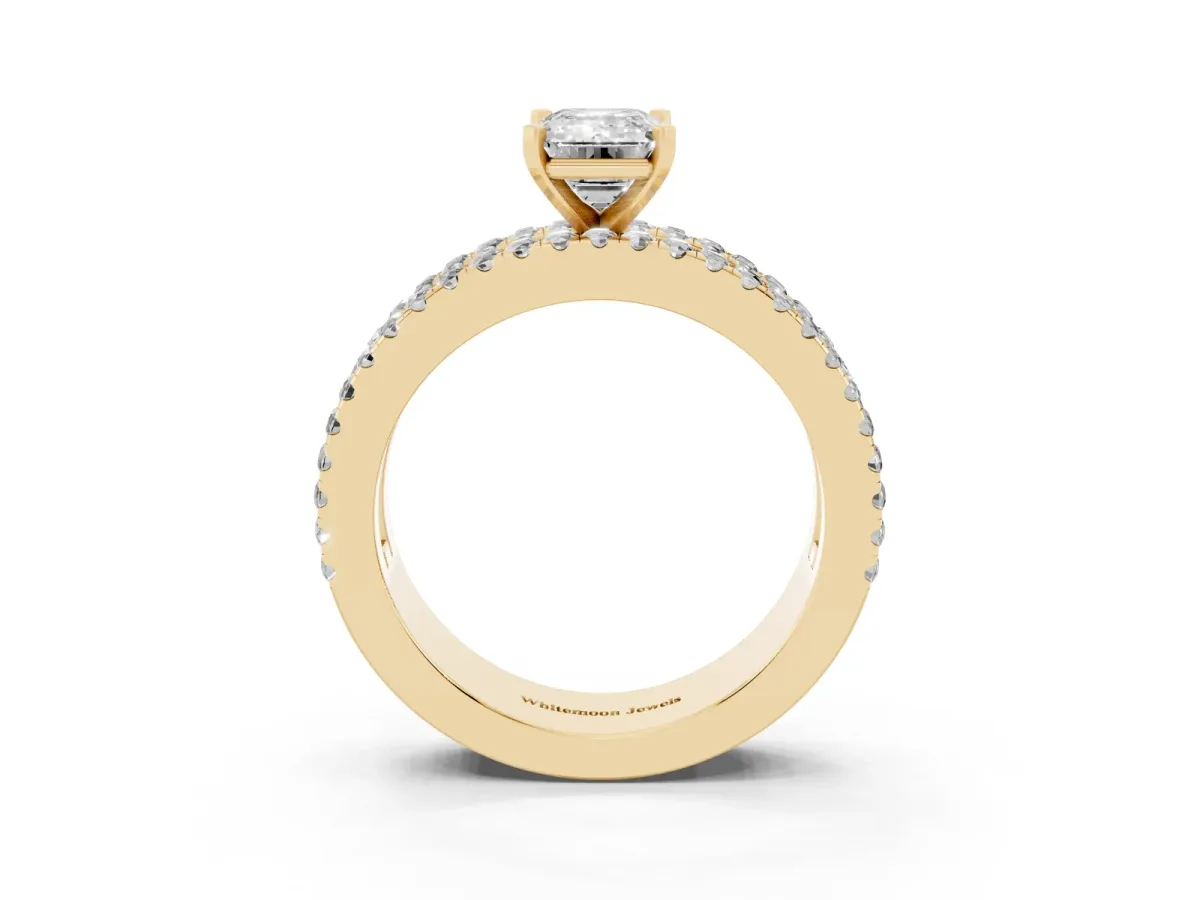 Emerald Cut Diamond Solitaire Ring with Pavé and Channel Set Band Yellow gold