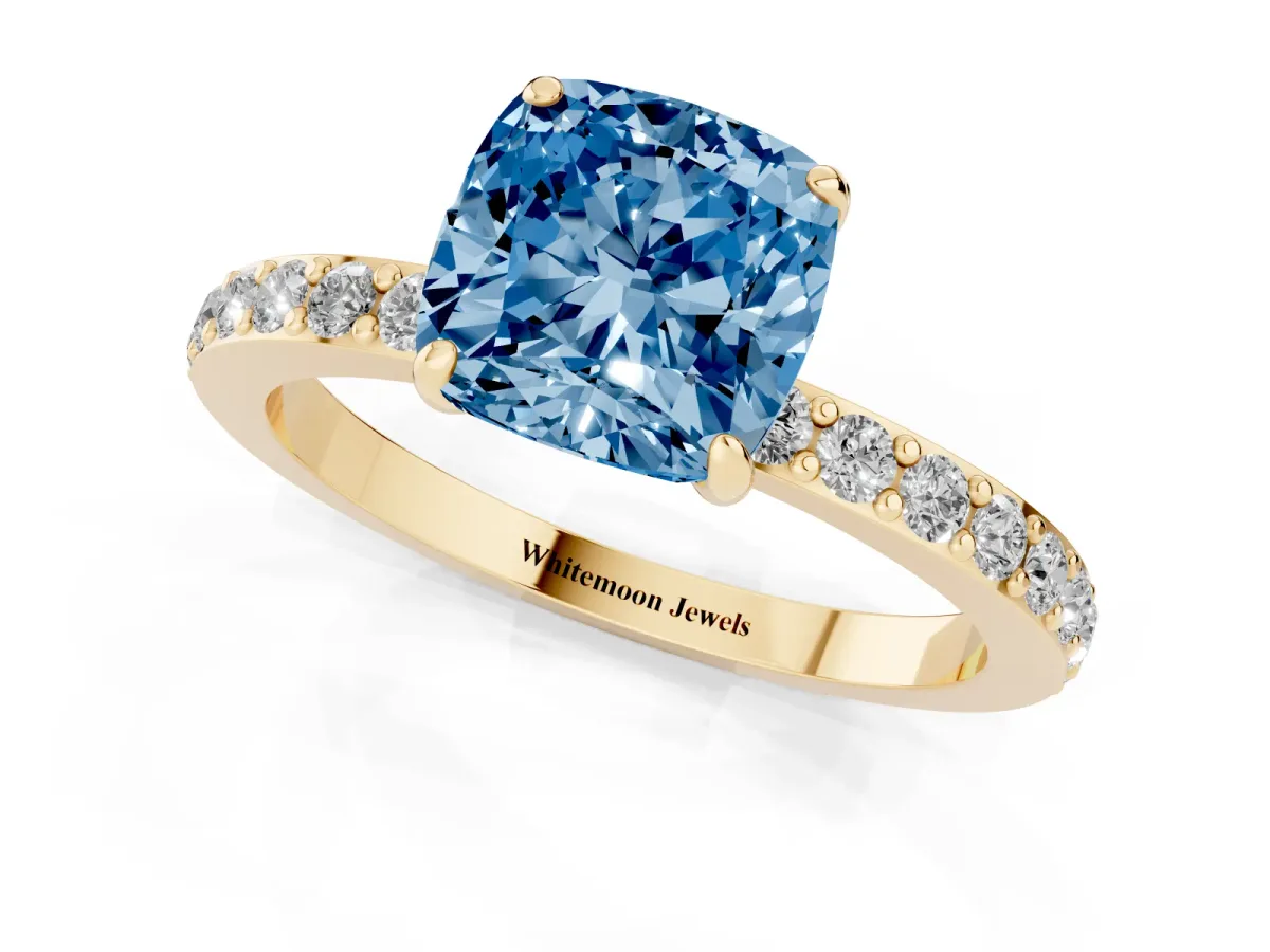 Fancy Blue Cushion Cut Diamond Pavé Engagement Ring with Round Accents and Prong Setting Yellow gold