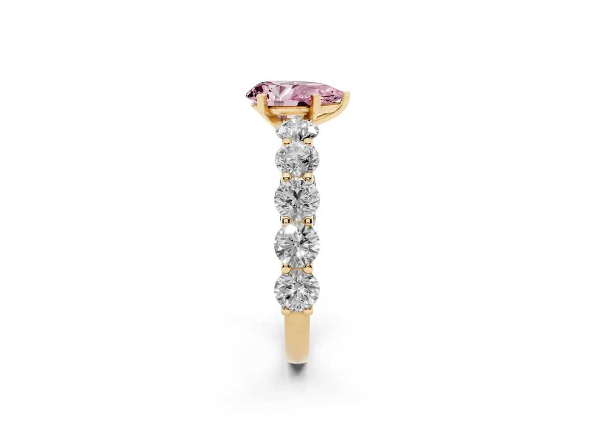 Fancy Pink Pear Cut Diamond Prong Setting with Side Stones on a Pave Band Yellow gold