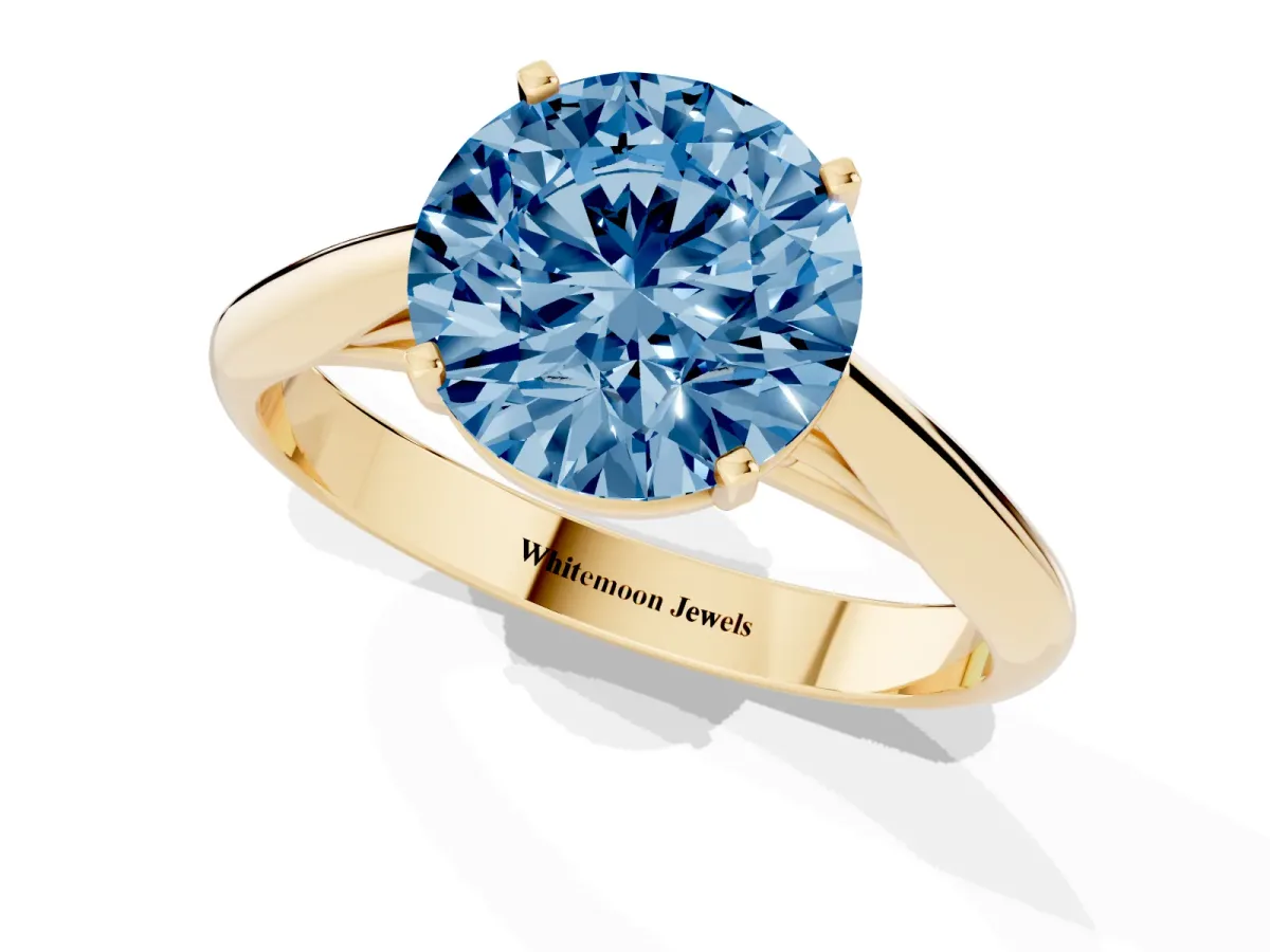 Fancy Blue Round Cut Diamond Solitaire Engagement Ring with Cathedral Setting and Four-Prong Mount Yellow gold