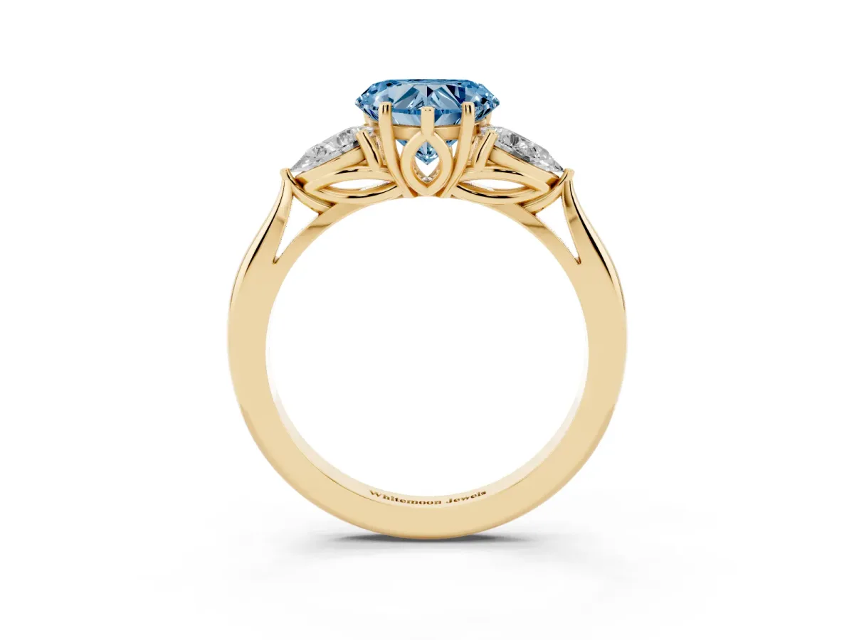 Fancy Blue Three-Stone Heart Cut Brilliant Diamond Solitaire Ring with Tapered Band and Four-Prong Setting Yellow gold
