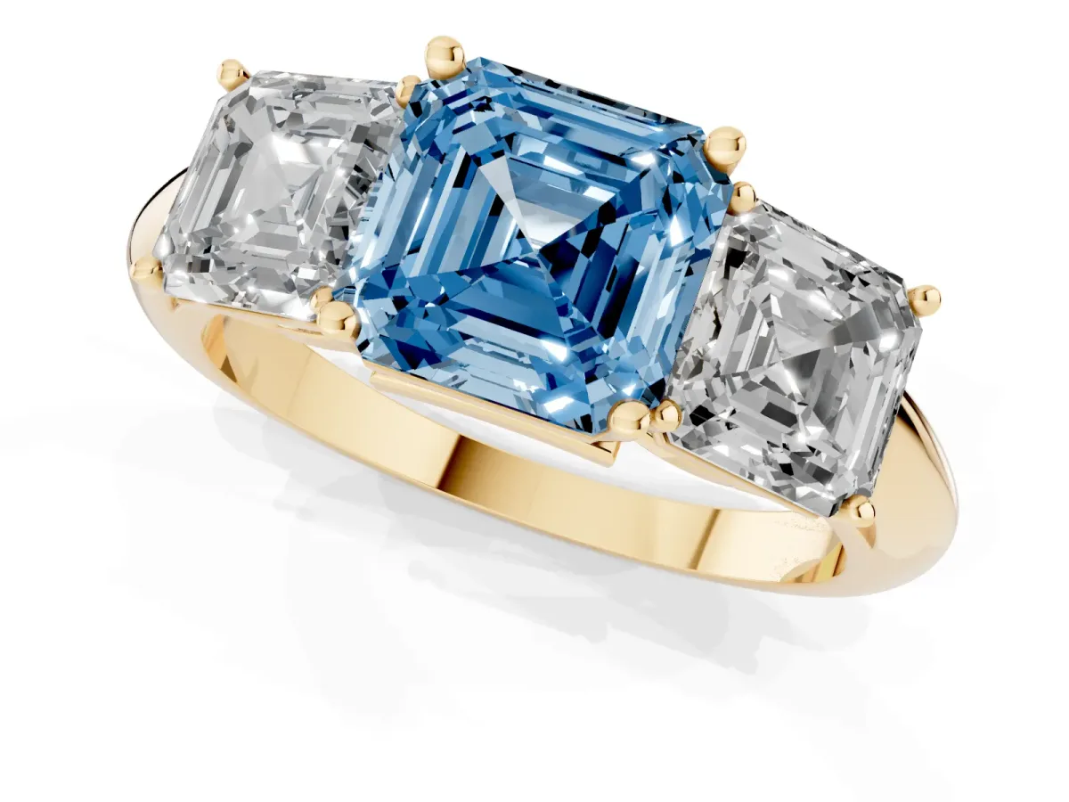Fancy Blue Three-Stone Asscher Cut Cut Diamond Engagement Ring with Prong Setting on a White Gold Band Yellow gold