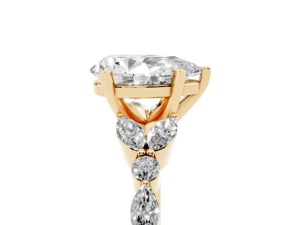 Pear Cut Diamond Solitaire Ring with Side Stones and Four-Prong Setting Yellow gold