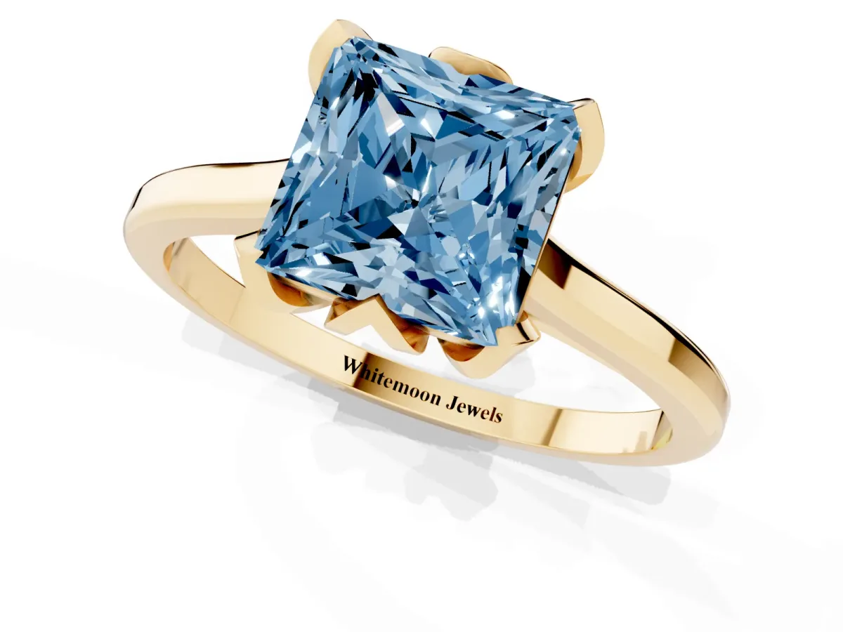 Fancy Blue Princess Cut Diamond Solitaire Ring with Flower Prong Setting and Classic Band Yellow gold