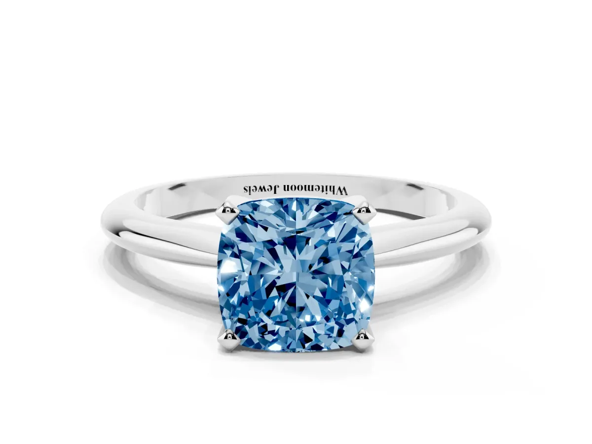 Fancy Blue Cushion Cut Cut Solitaire Ring with Four-Prong Setting on a Classic Band Silver