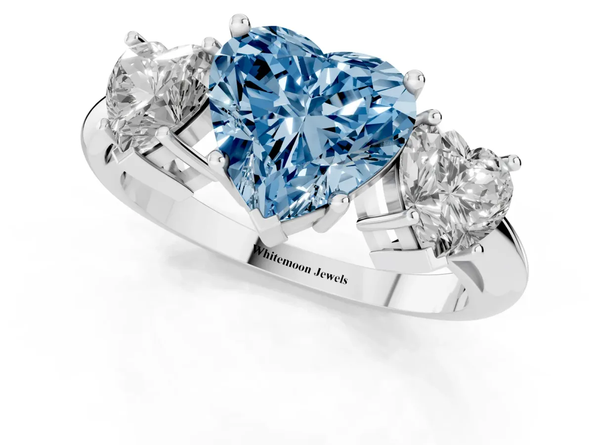 Fancy Blue Three-Stone Heart Cut Cut Diamond Engagement Ring with Prong Setting on a White Gold Band Platinum