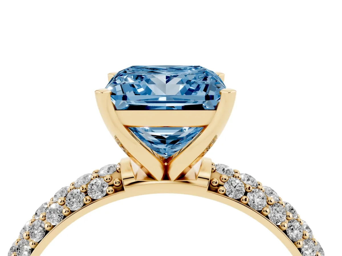 Fancy Blue Princess Cut Diamond Solitaire Ring with Prong Setting and Pavé Band Yellow gold