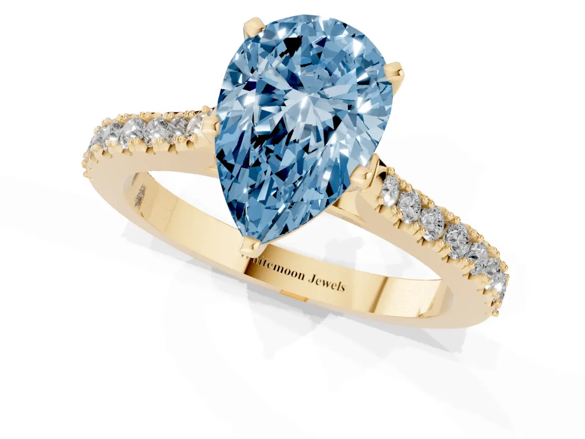Fancy Blue Pear Cut Cut Solitaire Diamond Engagement Ring with Pave Band and Four-Prong Setting Yellow gold