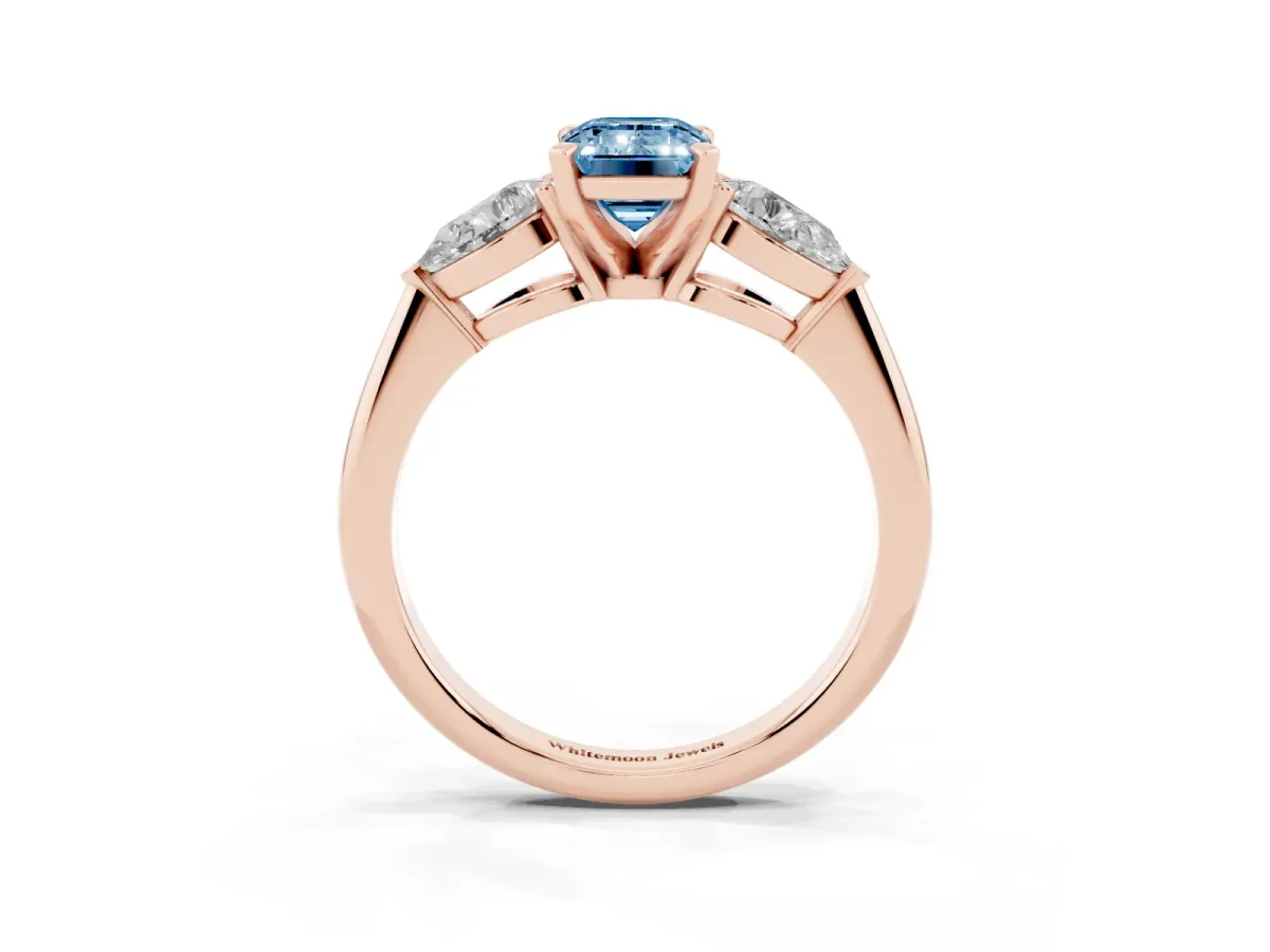 Fancy Blue Three-Stone Emerald Cut Diamond Ring with Pear Side Stones and Four-Prong Setting Rose gold