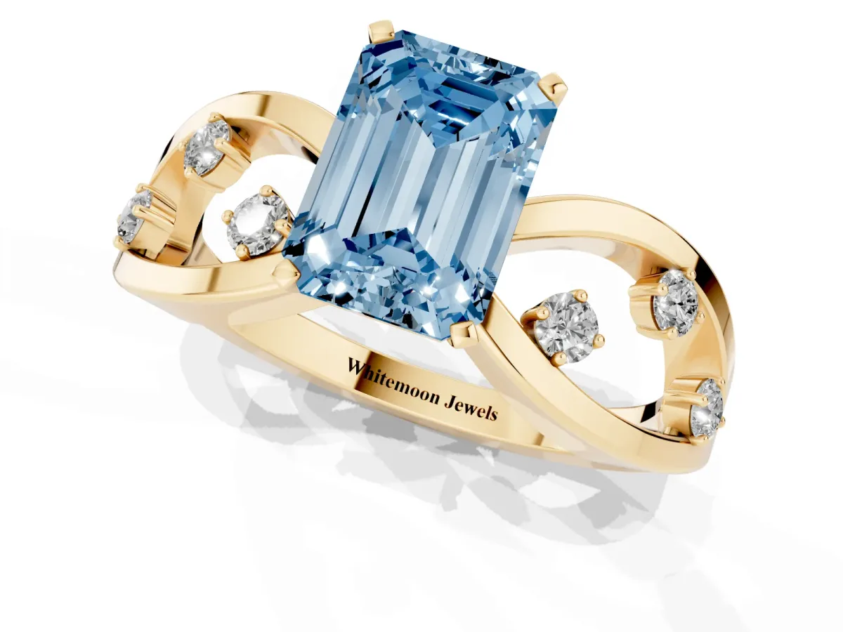 Fancy Blue Emerald Cut Cut Solitaire Diamond with Side Stones on Criss-Cross Band and Four-Prong Setting Yellow gold