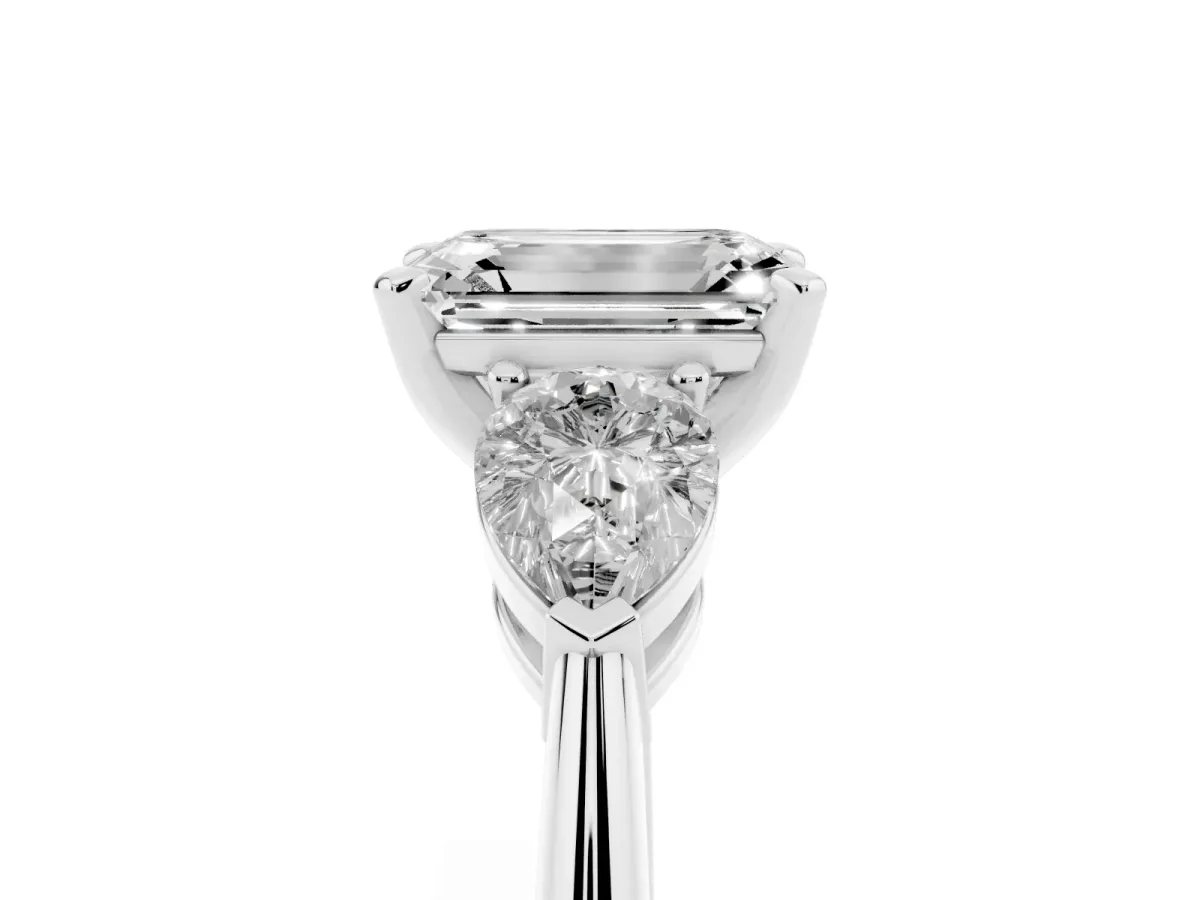 Three-Stone Emerald Cut Diamond Ring with Pear Side Stones and Four-Prong Setting Platinum