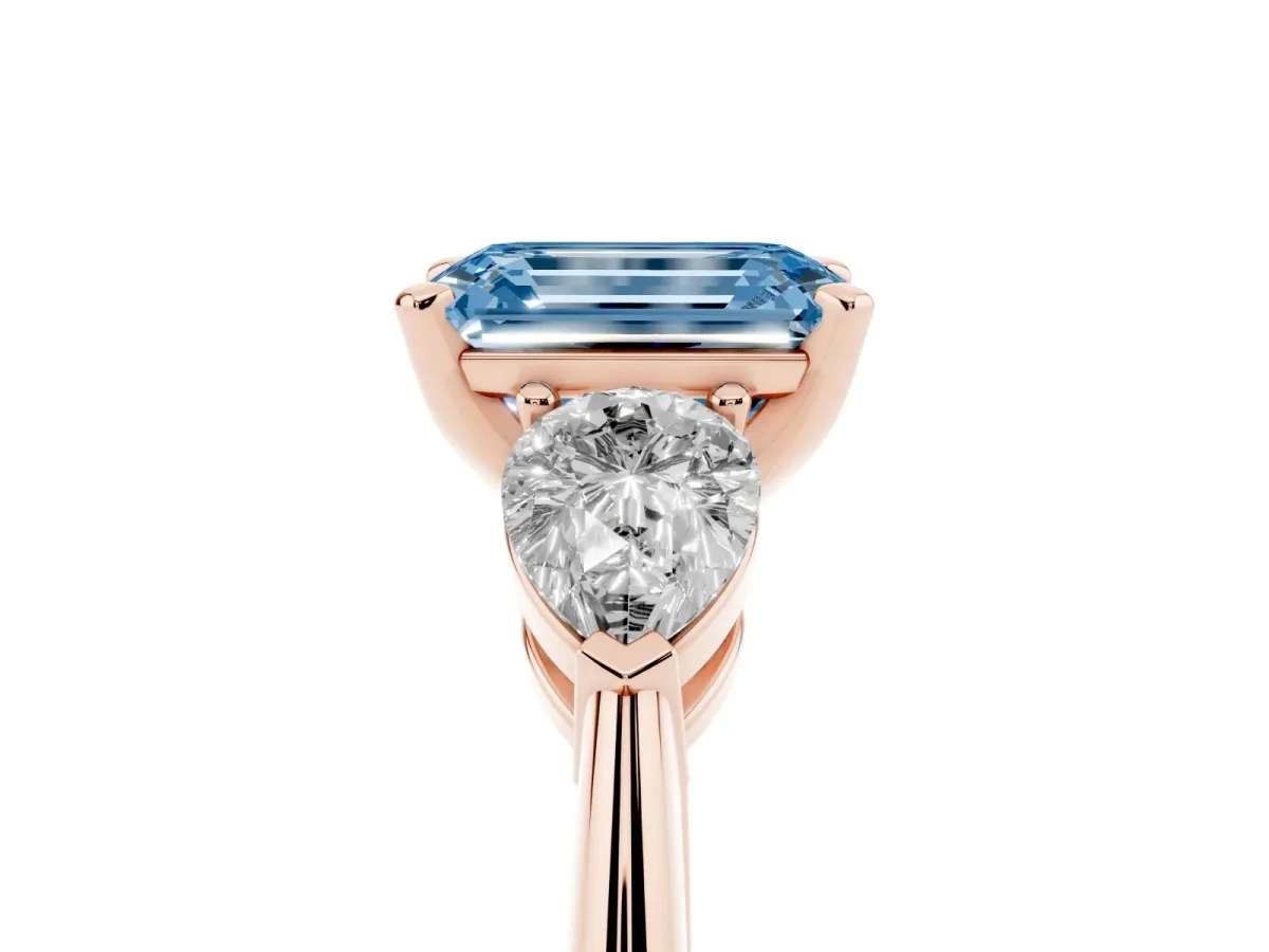 Fancy Blue Three-Stone Emerald Cut Diamond Ring with Pear Side Stones and Four-Prong Setting Rose gold