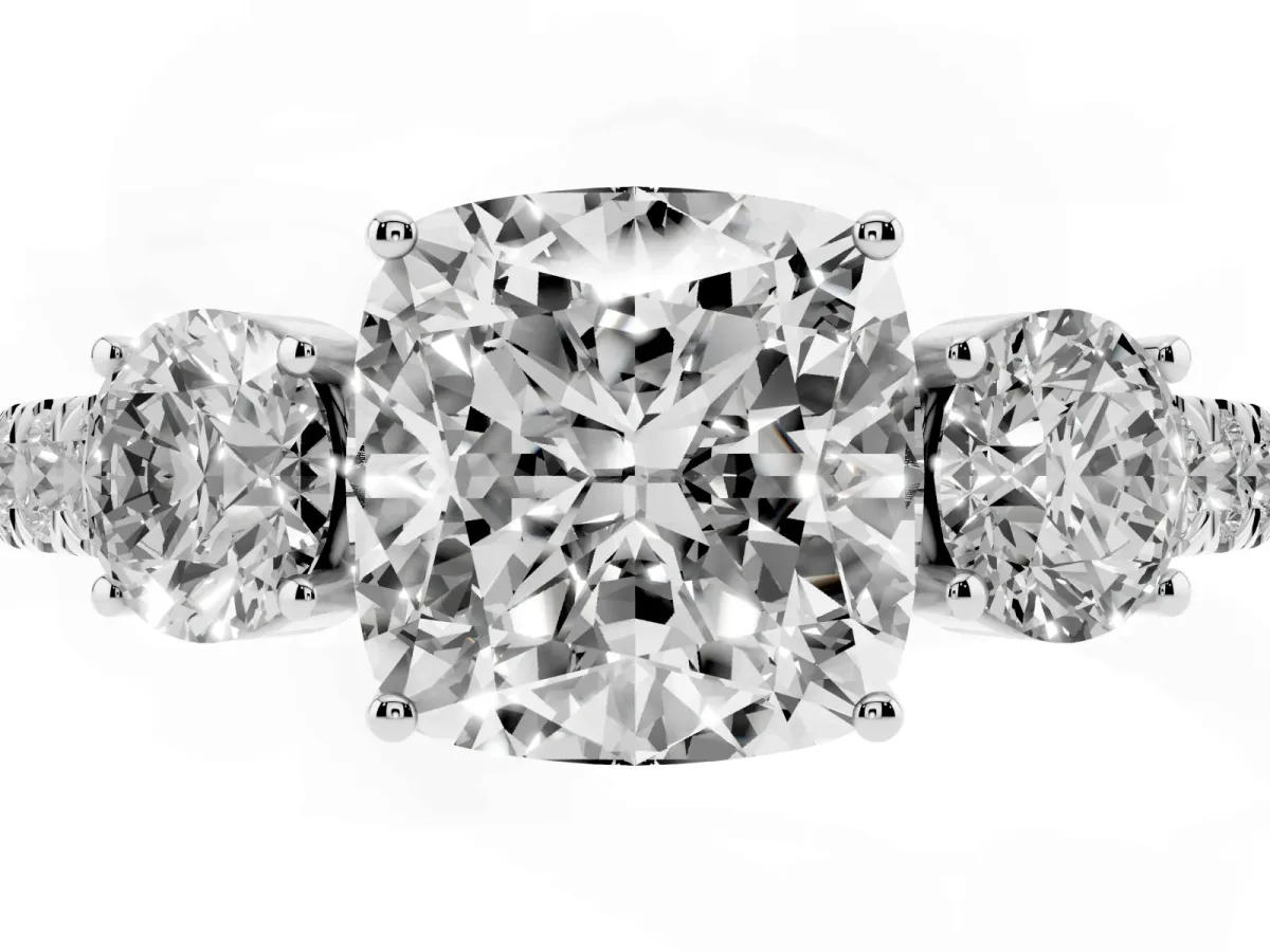 Cushion Cut Cut Diamond Three-Stone Ring with Round Side Stones and Pavé Band Platinum