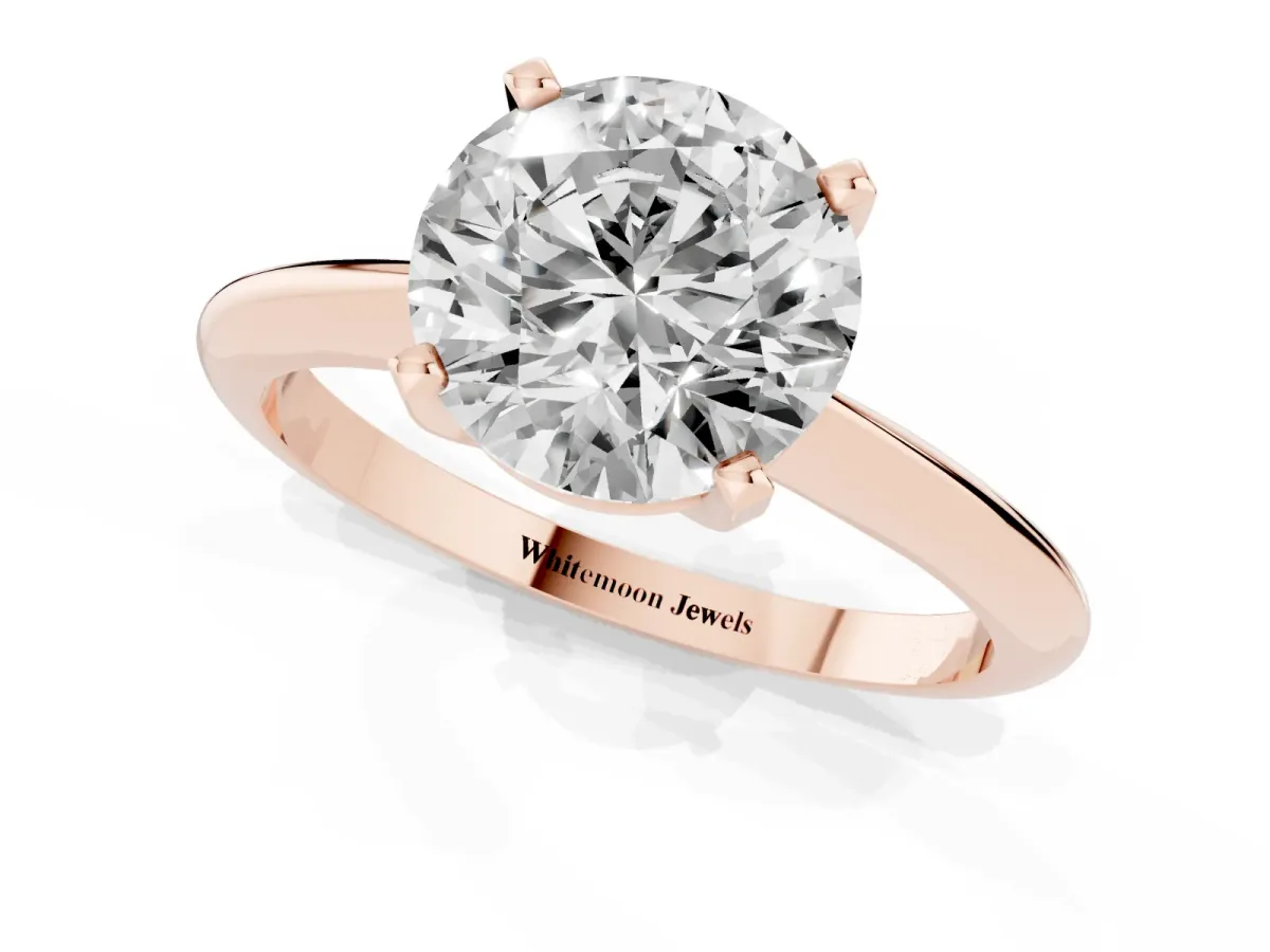 Round Cut Cut Solitaire Ring with Four-Prong Setting on a Classic Band Rose gold