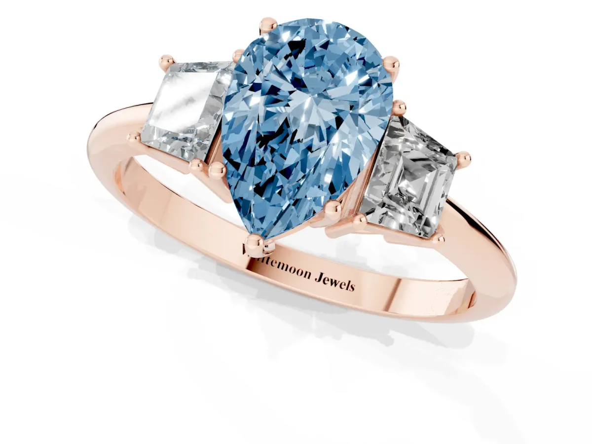 Fancy Blue Pear Cut Diamond Three-Stone Ring with Trapezoid Side Stones and Prong Setting Rose gold