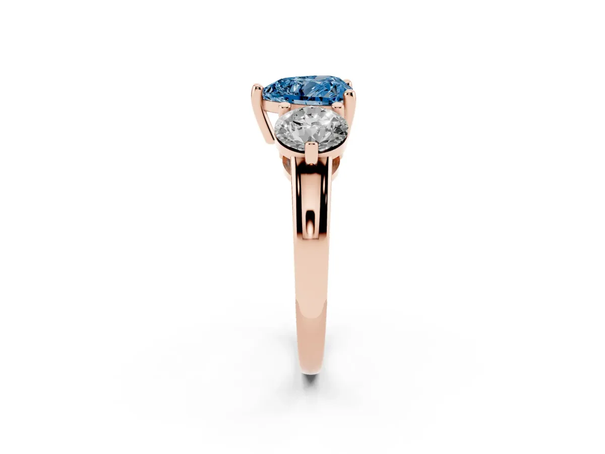 Fancy Blue Three-Stone Heart Cut Brilliant Cut Solitaire Ring with Prong Setting on a Classic Band Rose gold