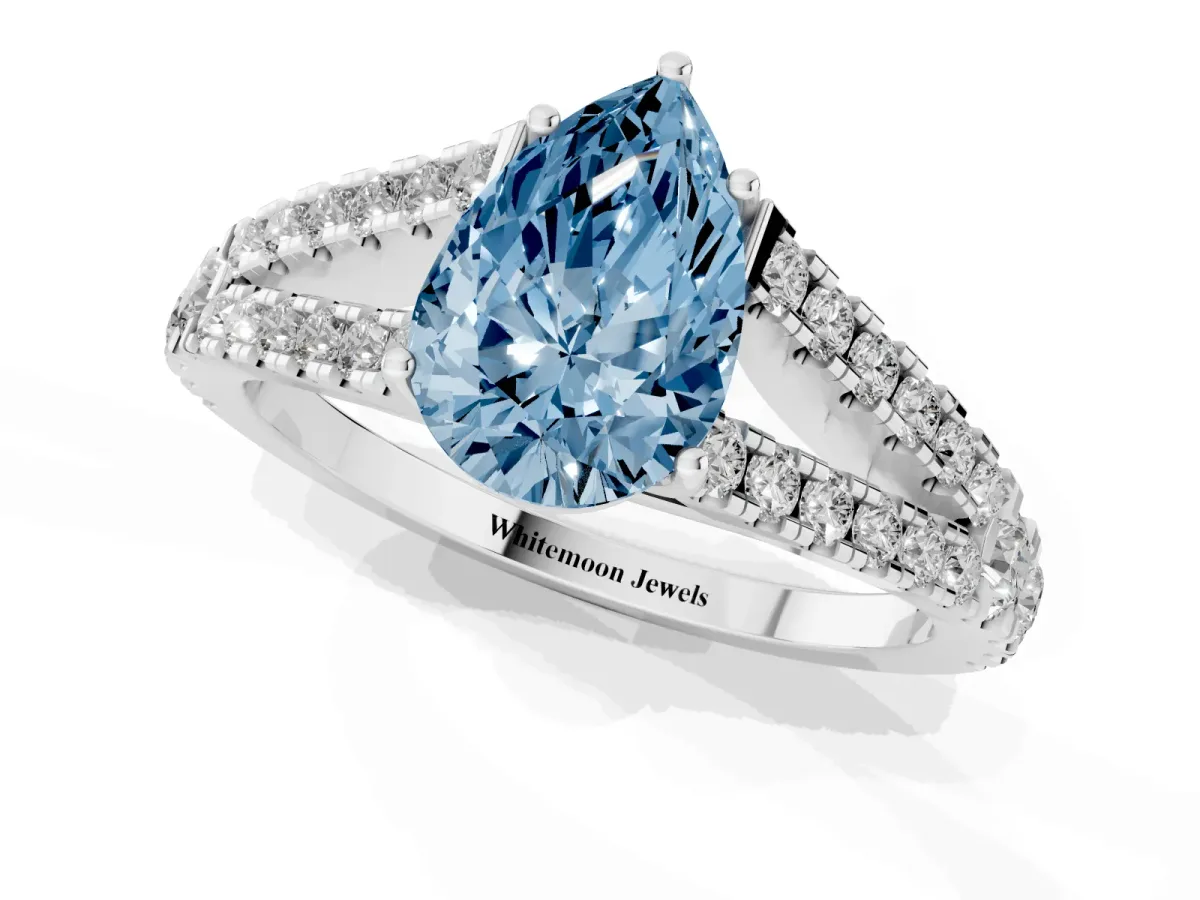 Fancy Blue Pear Cut Diamond Split Shank Engagement Ring with Round Pavé and Prong Setting Platinum