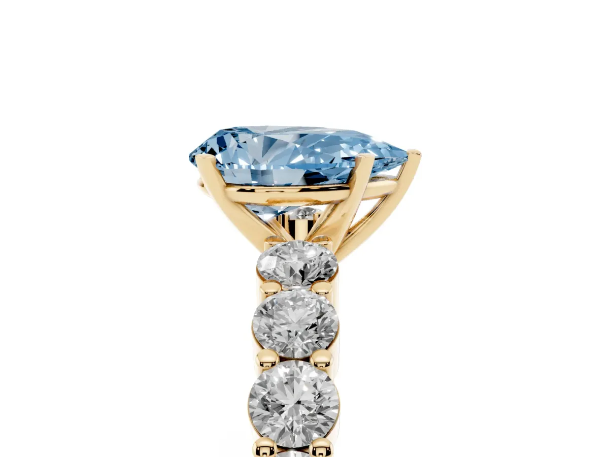 Fancy Blue Pear Cut Diamond Solitaire Ring with Shared Prong Round Side Stones Yellow gold