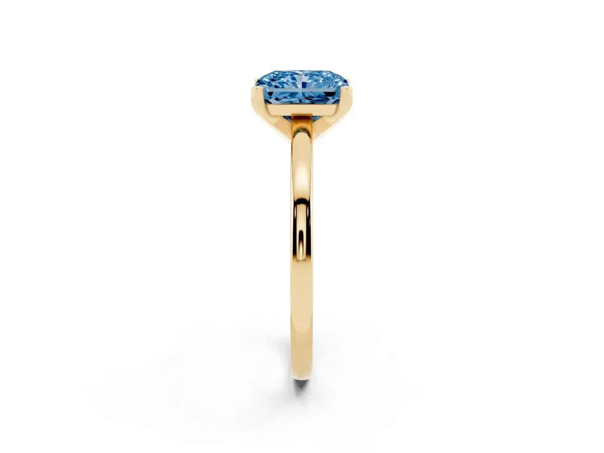Fancy Blue Radiant Cut Solitaire Diamond Engagement Ring with Four-Prong Setting on a Classic Band Yellow gold