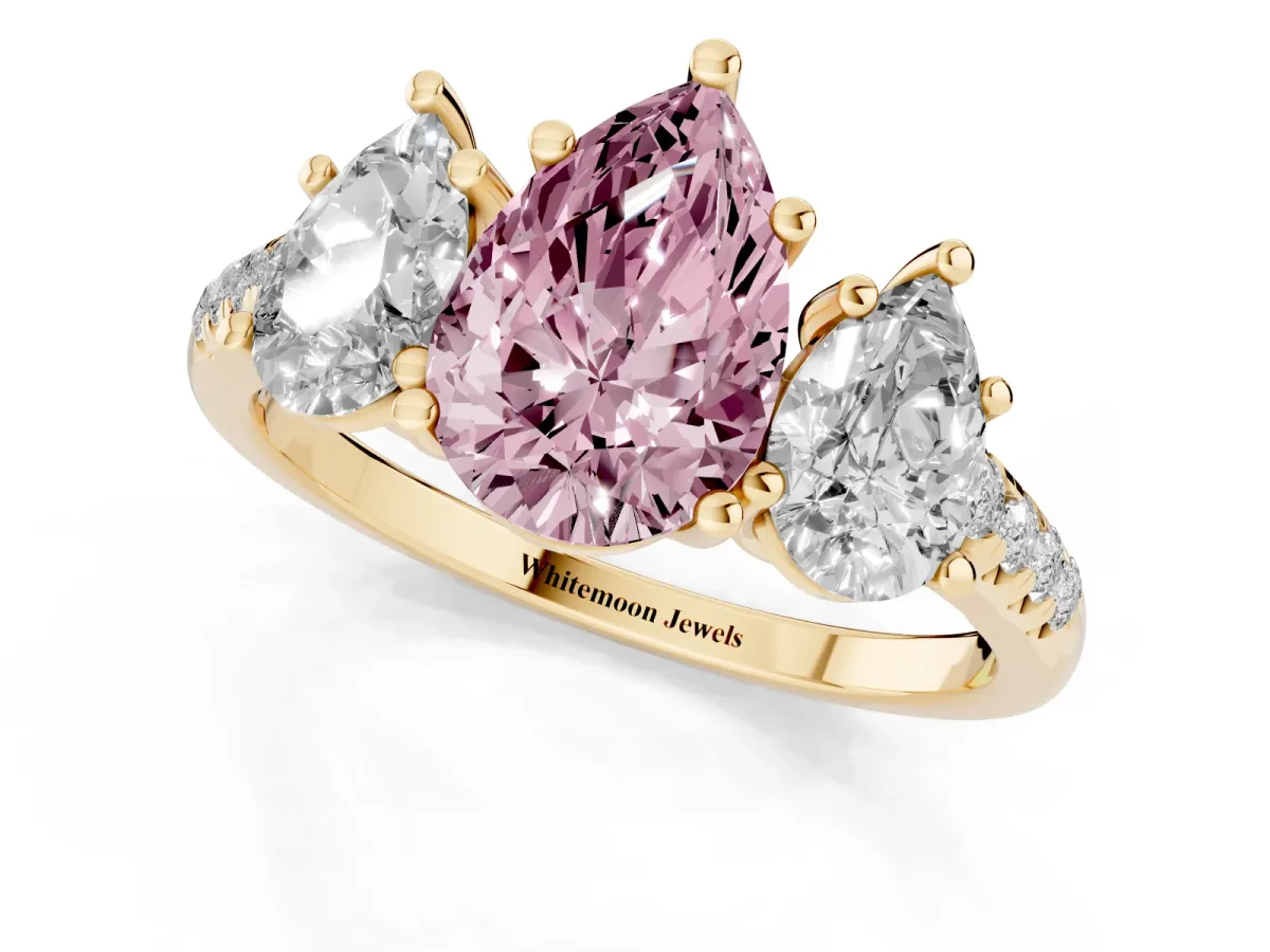 Fancy Pink Three-Stone Pear Cut Diamond Ring with Round Pavé Band and Prong Setting Yellow gold