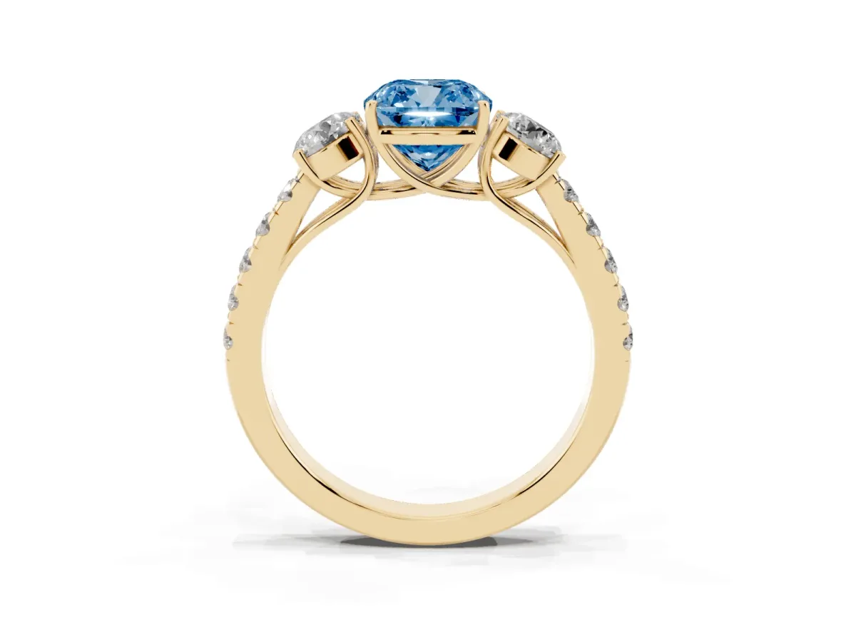 Fancy Blue Cushion Cut Cut Diamond Three-Stone Ring with Round Side Stones and Pavé Band Yellow gold