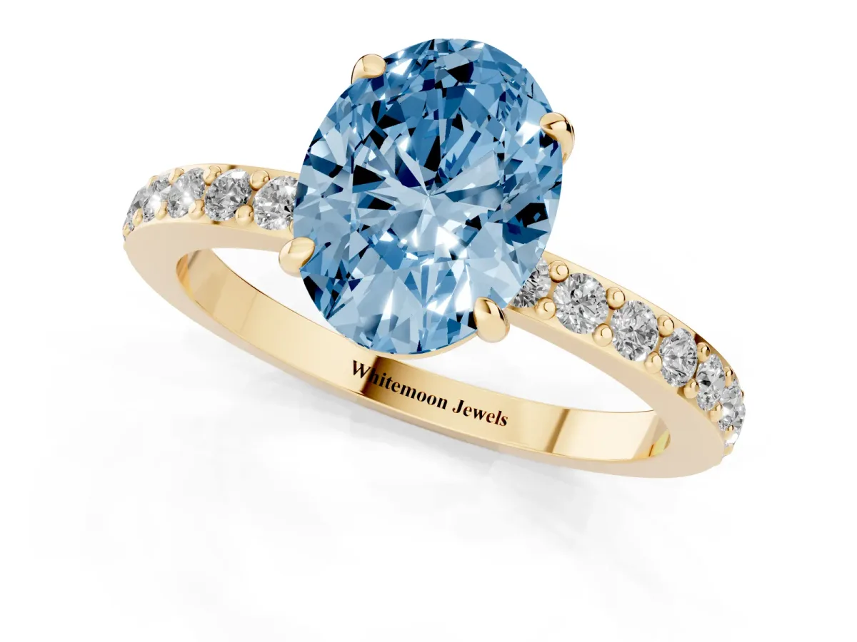 Fancy Blue Oval Cut Diamond Pavé Engagement Ring with Round Accents and Prong Setting Yellow gold