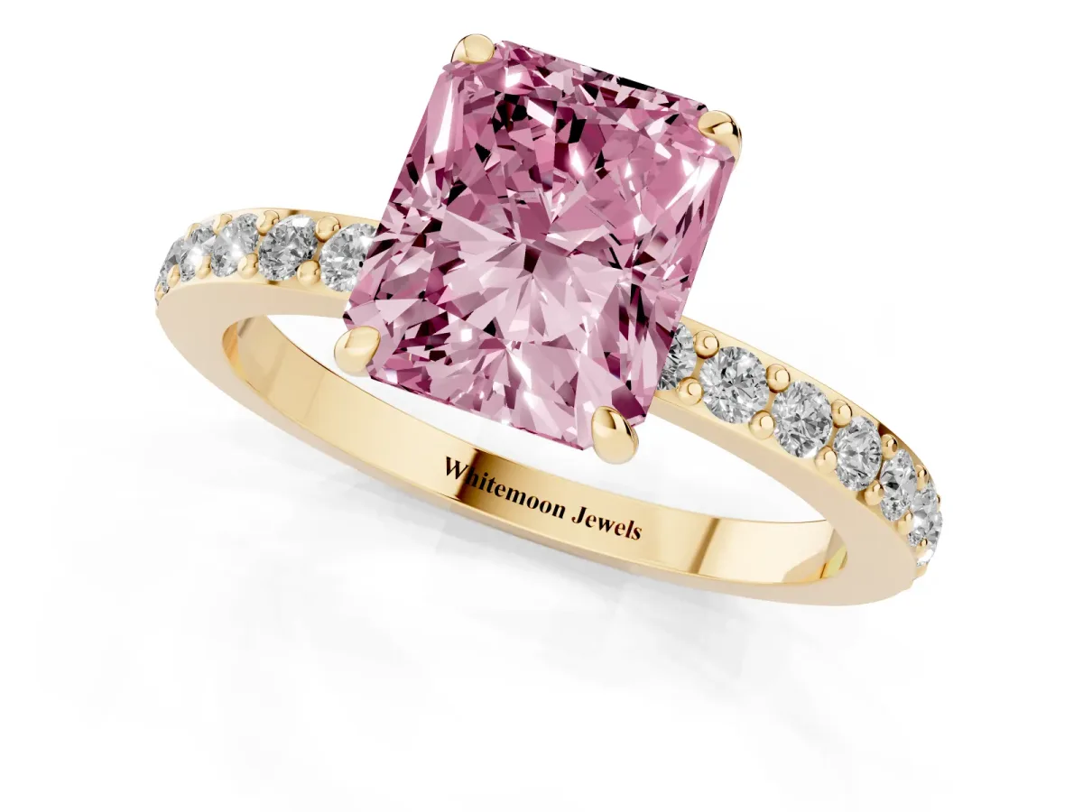 Fancy Pink Radiant Cut Diamond Pavé Engagement Ring with Round Accents and Prong Setting Yellow gold