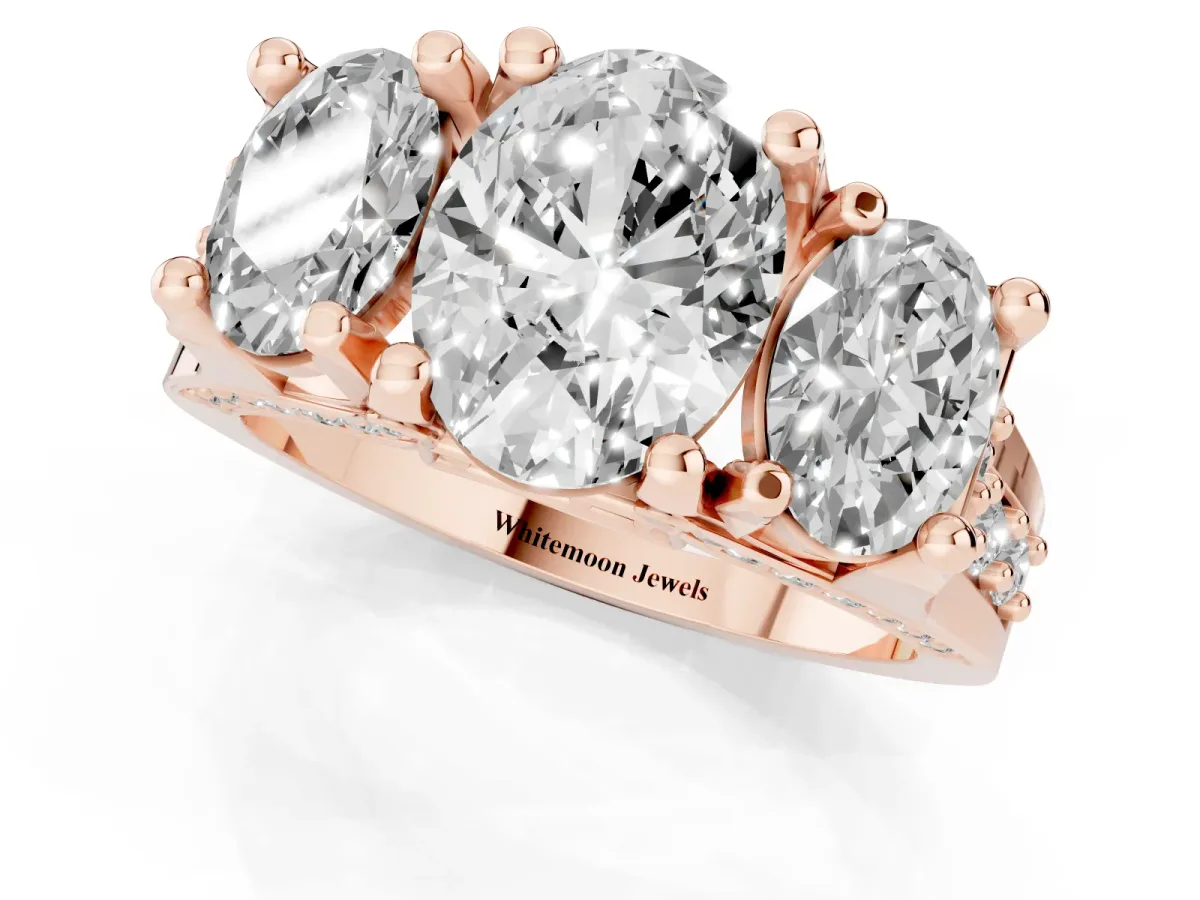 Oval Cut Diamond Three-Stone Ring with Channel Set Band and Four-Prong Setting Rose gold