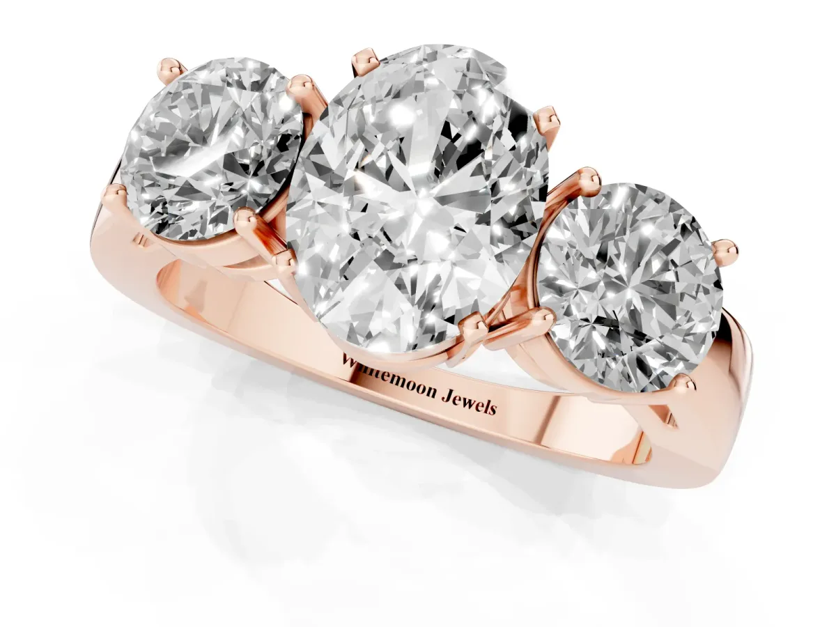 Three-Stone Oval Cut Diamond Ring with Round Side Stones, Classic Band, and Four-Prong Setting Rose gold