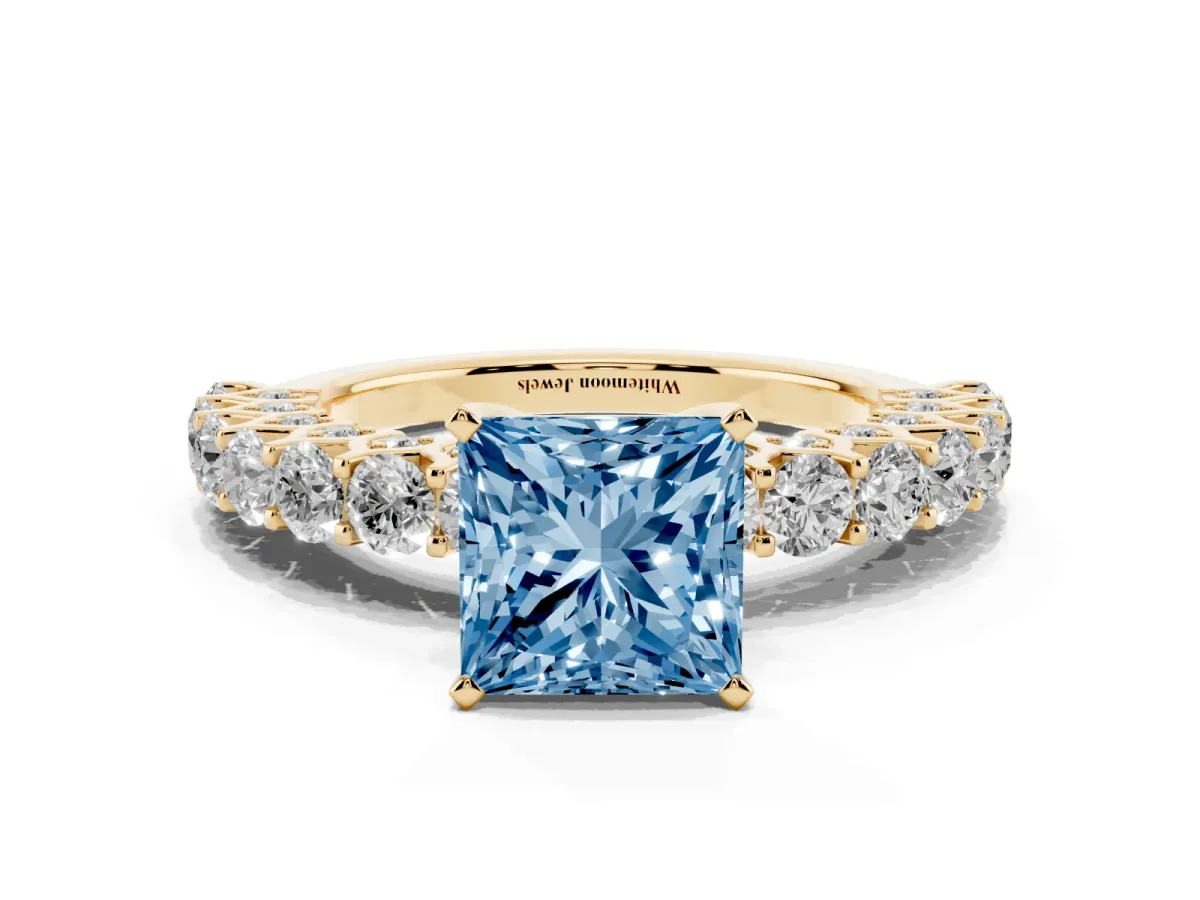 Fancy Blue Princess Cut Diamond Solitaire Ring with Shared Prong Pavé Band and Four-Prong Setting Yellow gold