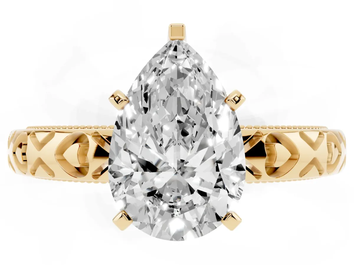 Pear Cut Solitaire Diamond Engagement Ring with XO Engraved Band and Four-Prong Setting Yellow gold